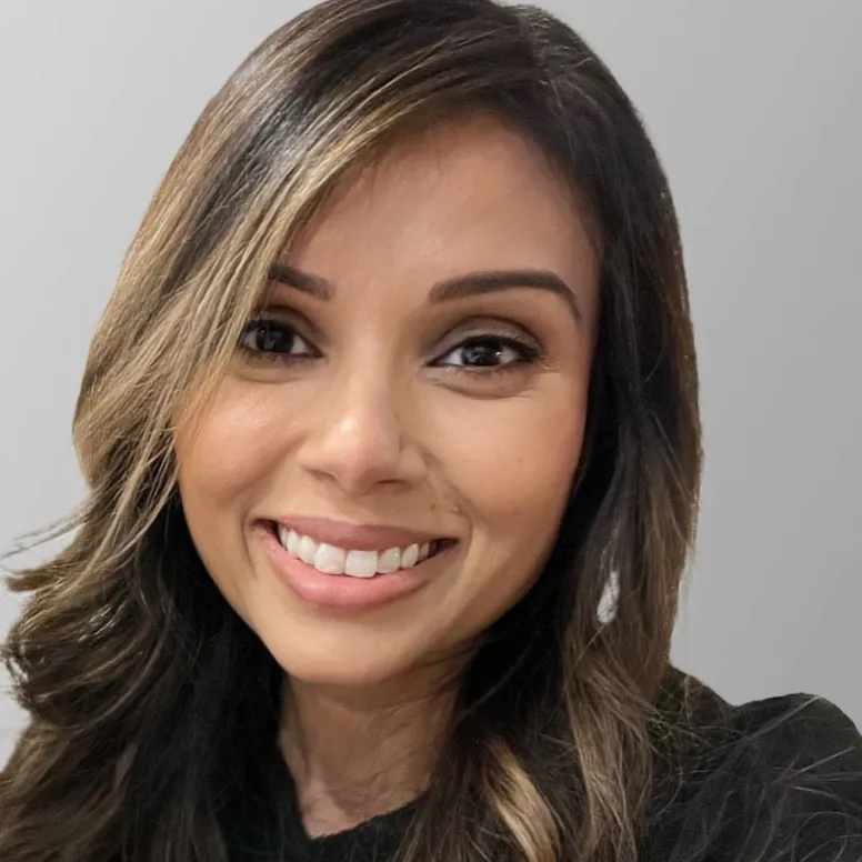Smiling woman with long brown hair.