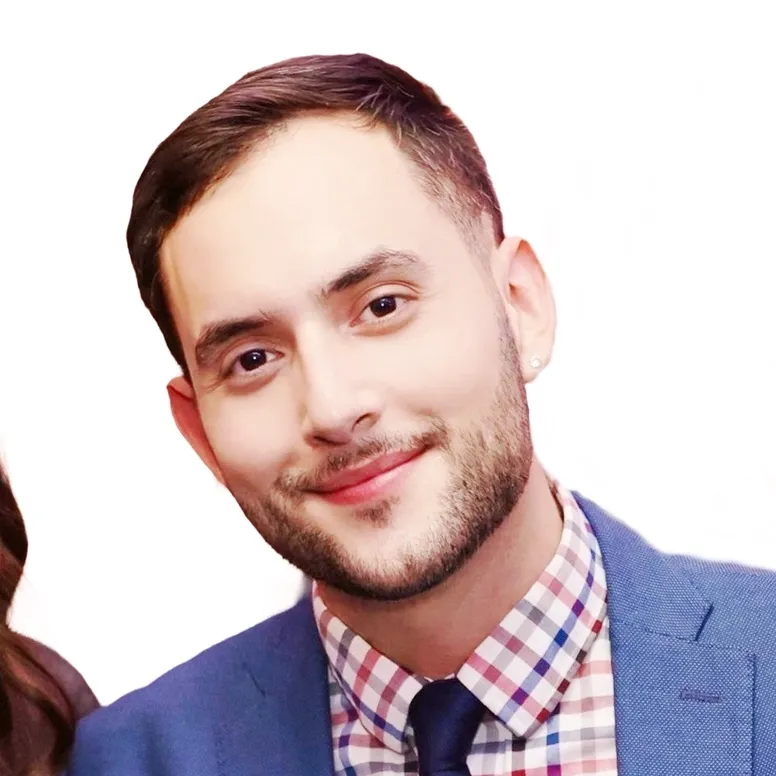 Smiling man in suit and checkered shirt.